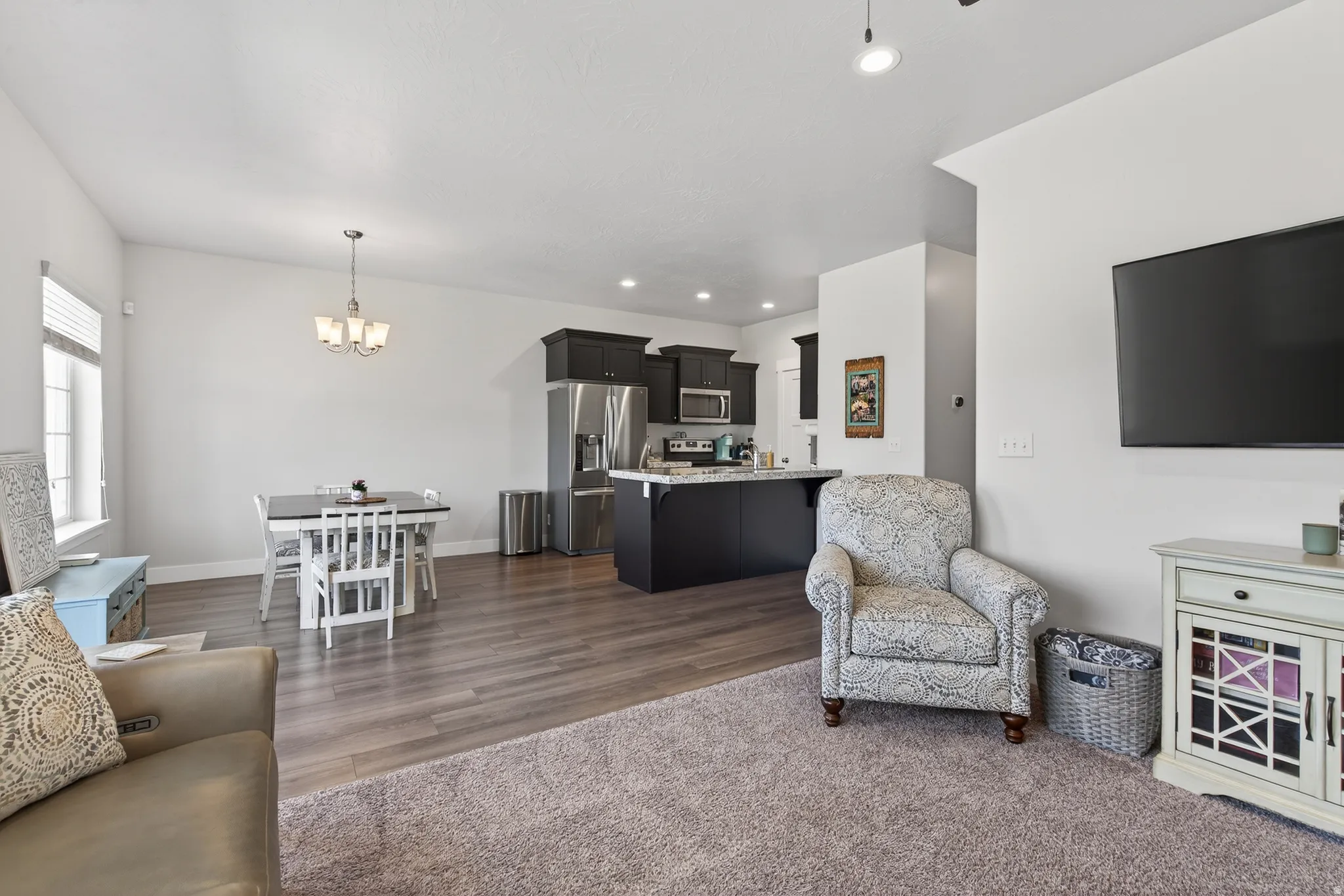 Living room featuring a chandelier and dark wood finished floors