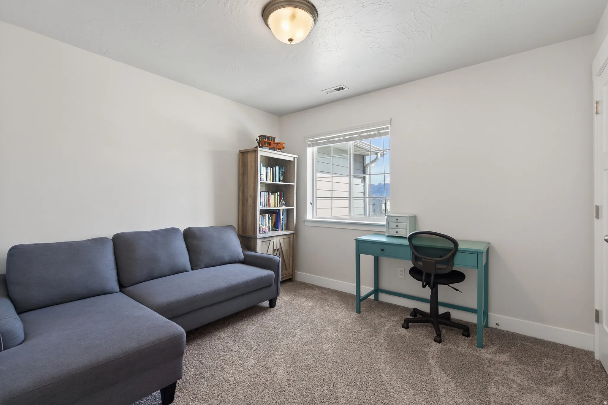 Office space featuring baseboards and carpet