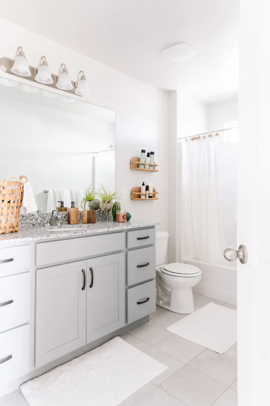 Bathroom featuring vanity, shower / tub combo with curtain, and light tile patterned flooring
