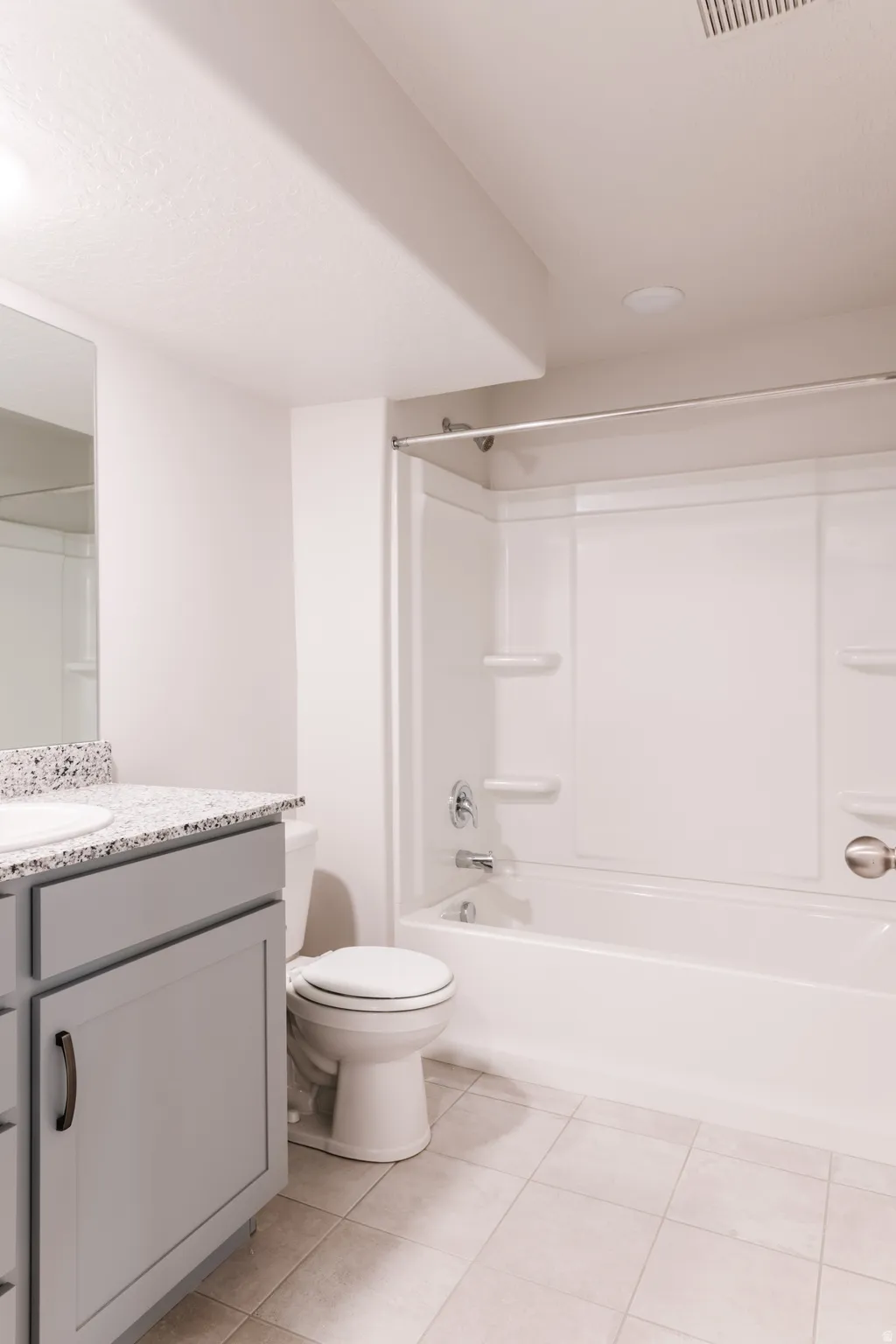 Full bathroom with vanity, shower / bath combination, and light tile patterned floors