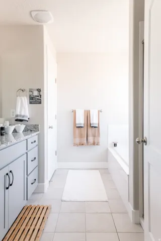 Bathroom with vanity, a garden tub, light tile patterned floors, and a textured ceiling
