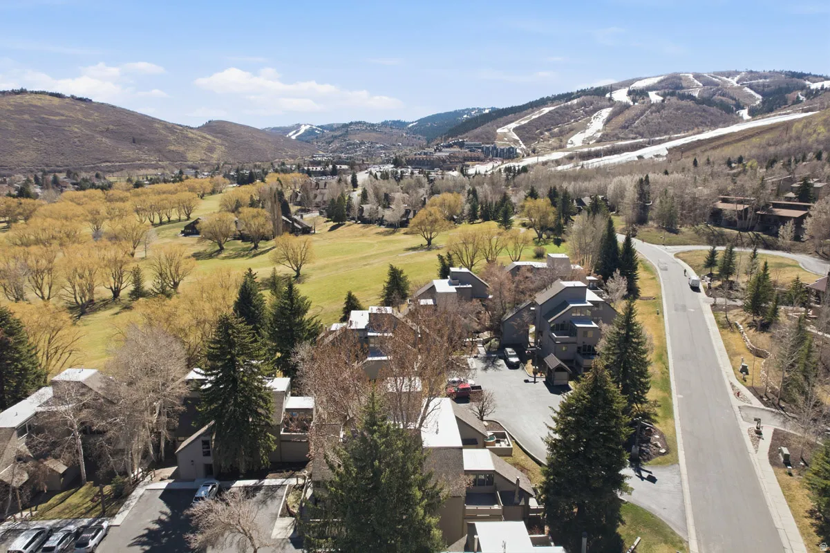 Aerial view of property's location featuring a mountainous background