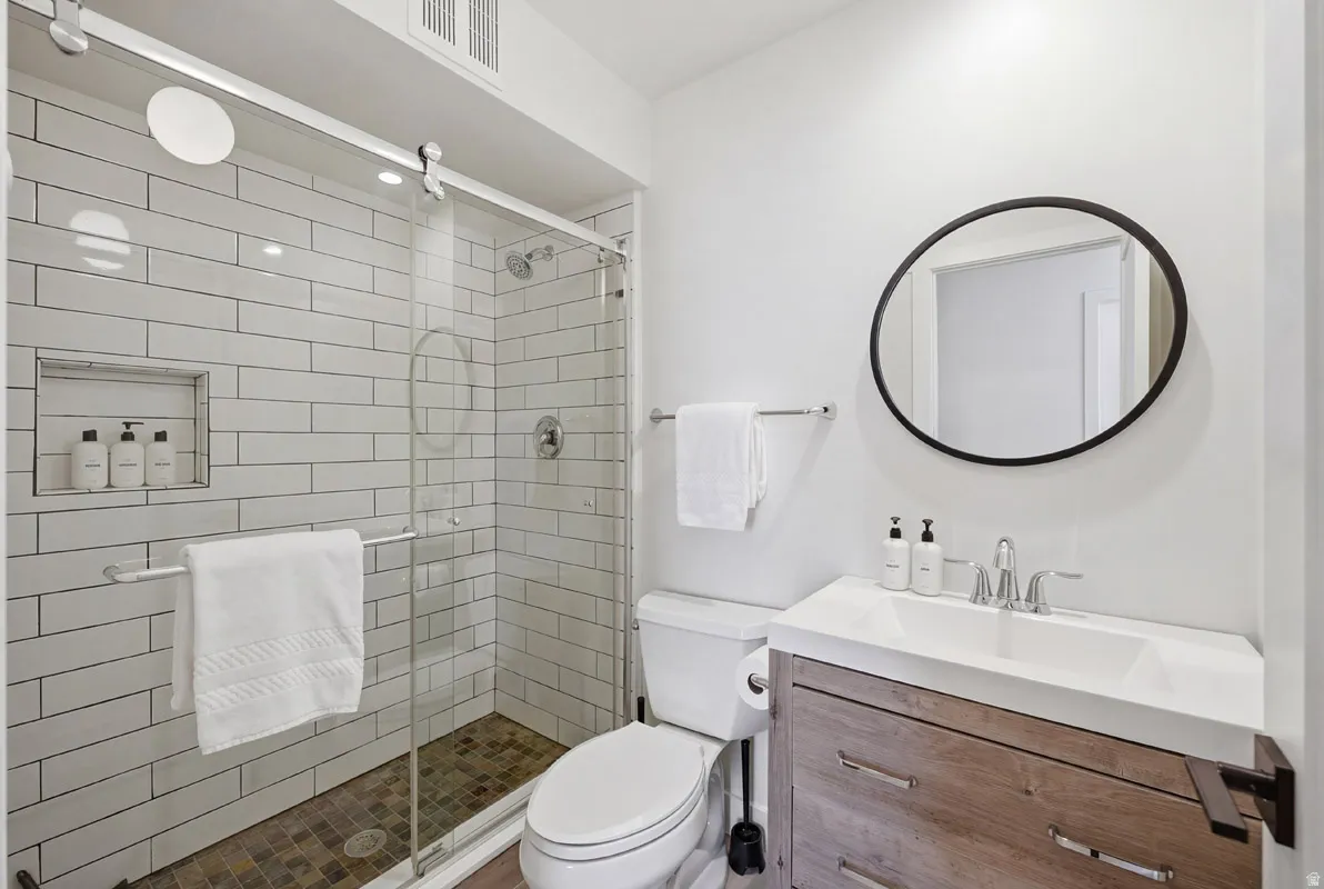 Full bath featuring vanity and a stall shower