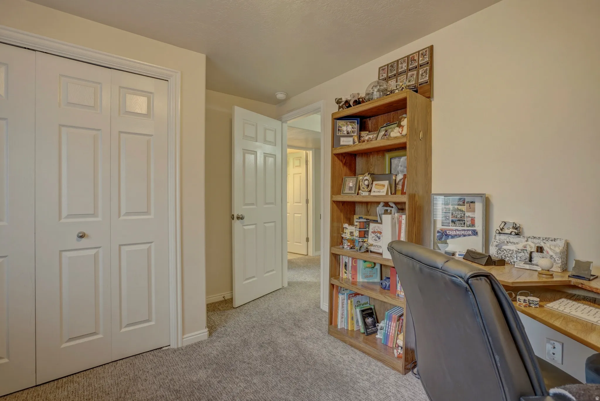 Home office featuring light carpet and baseboards