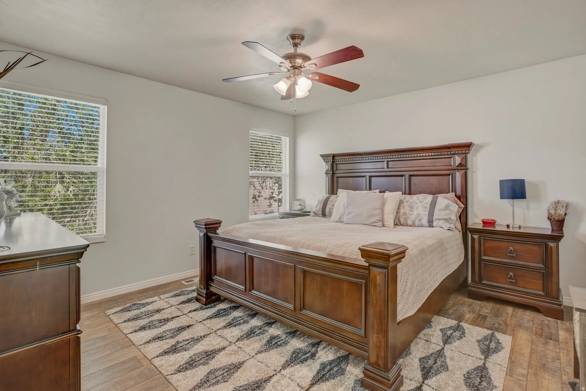 Bedroom with light wood-style floors and ceiling fan