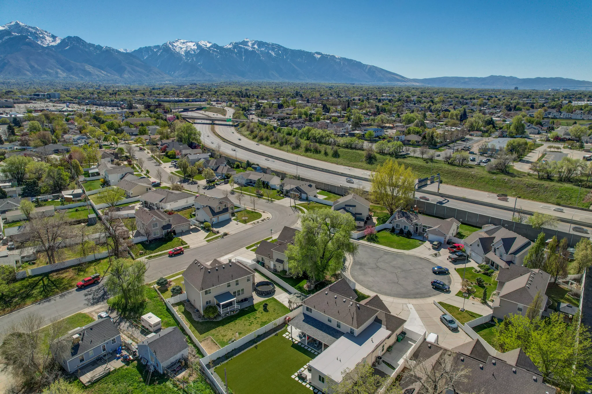 Aerial perspective of suburban area with a mountainous background