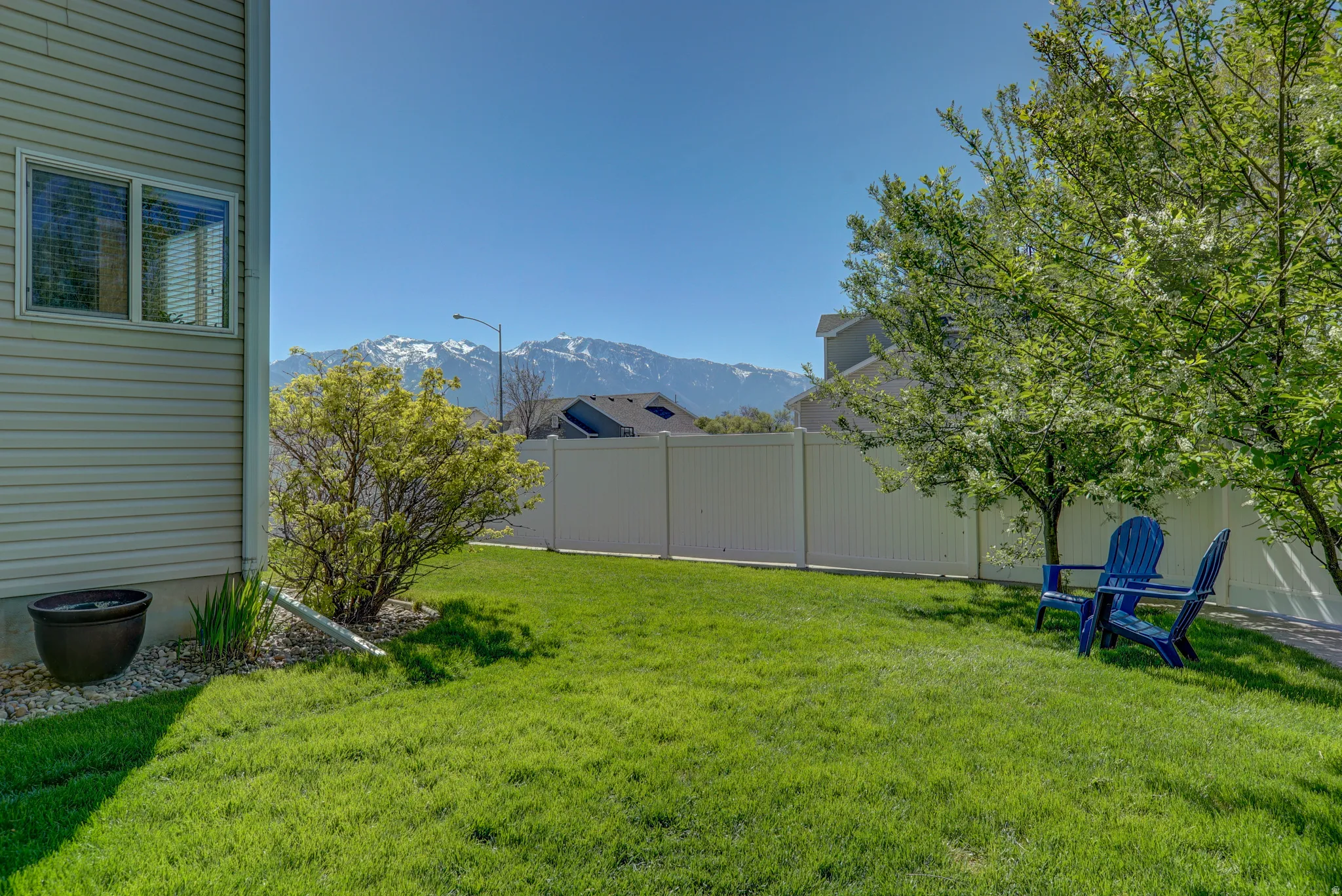 Fenced yard featuring a mountain view