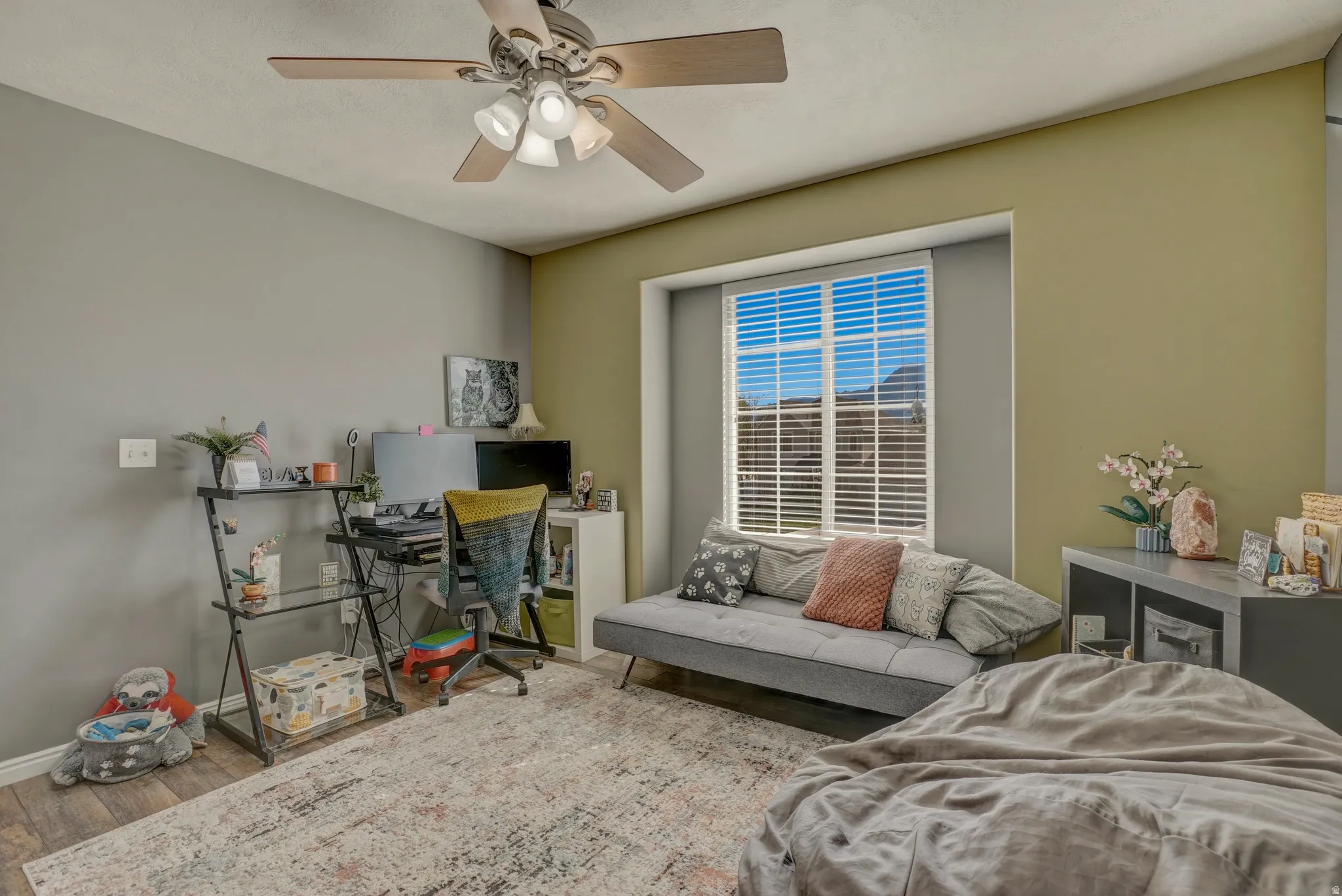 Bedroom with ceiling fan, wood finished floors, and a desk