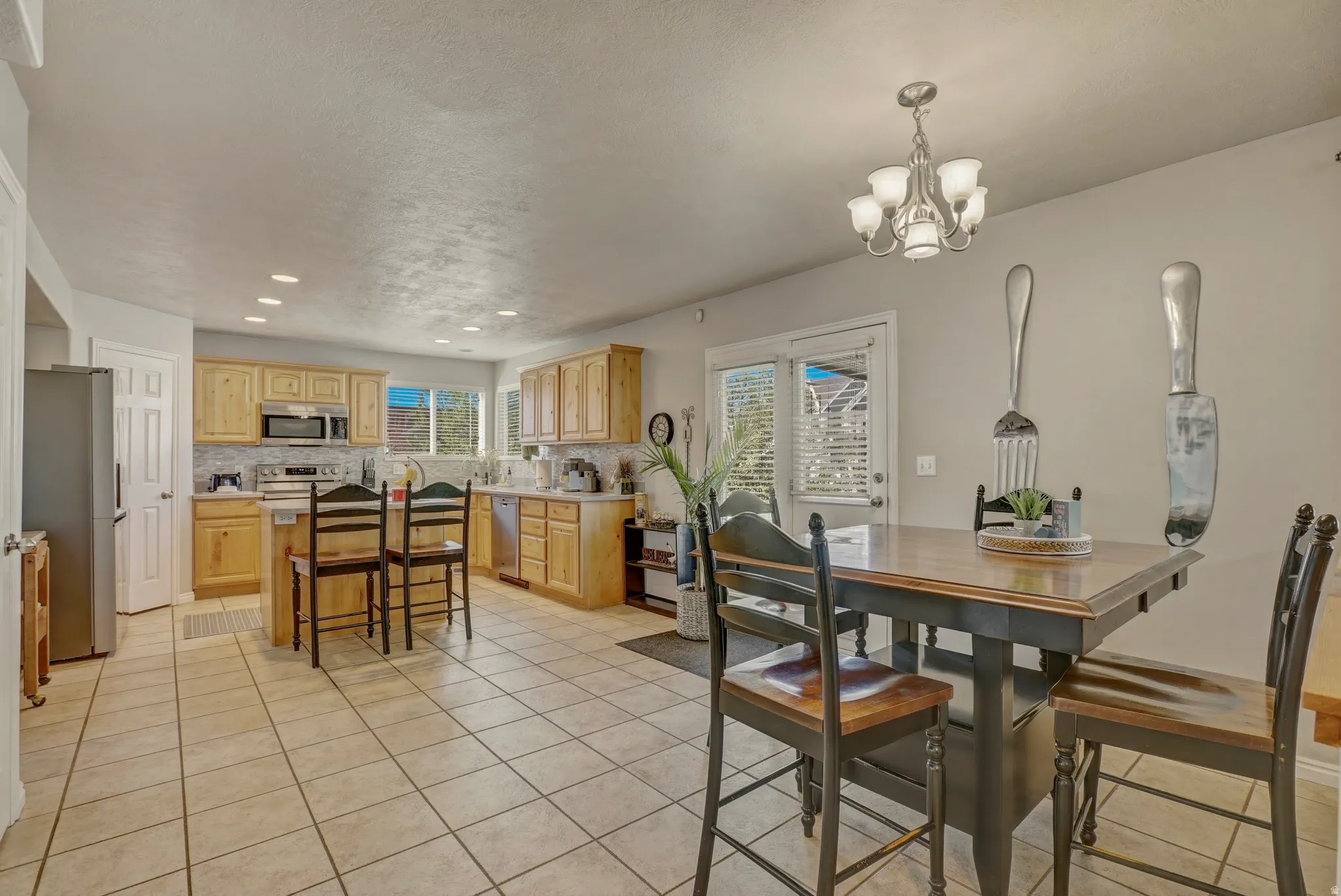 Dining room featuring light tile patterned floors and hanging lights