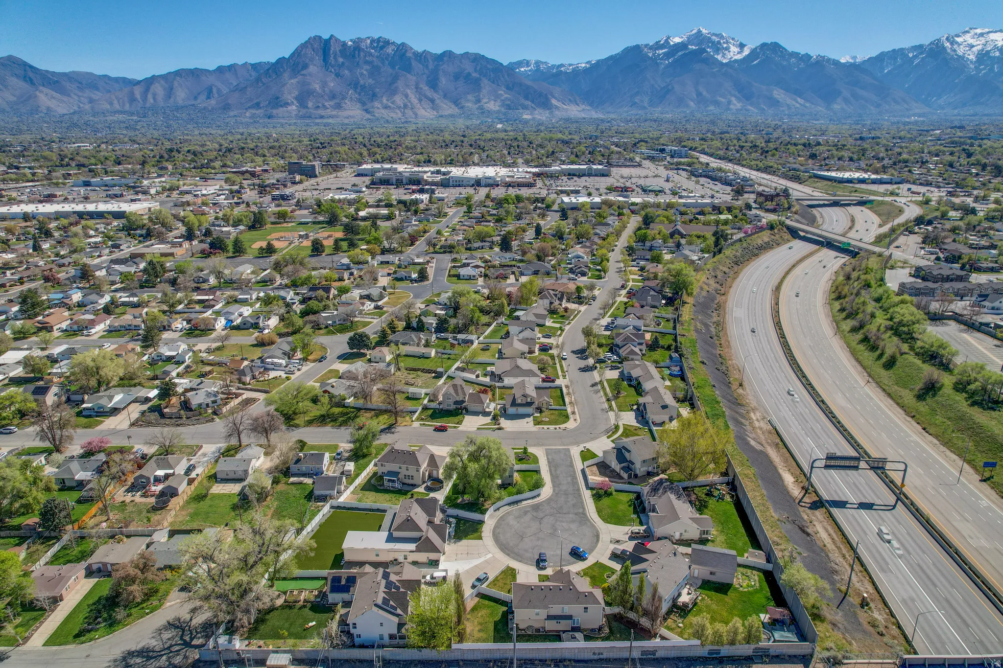 Aerial view of property's location with mountains and nearby suburban area