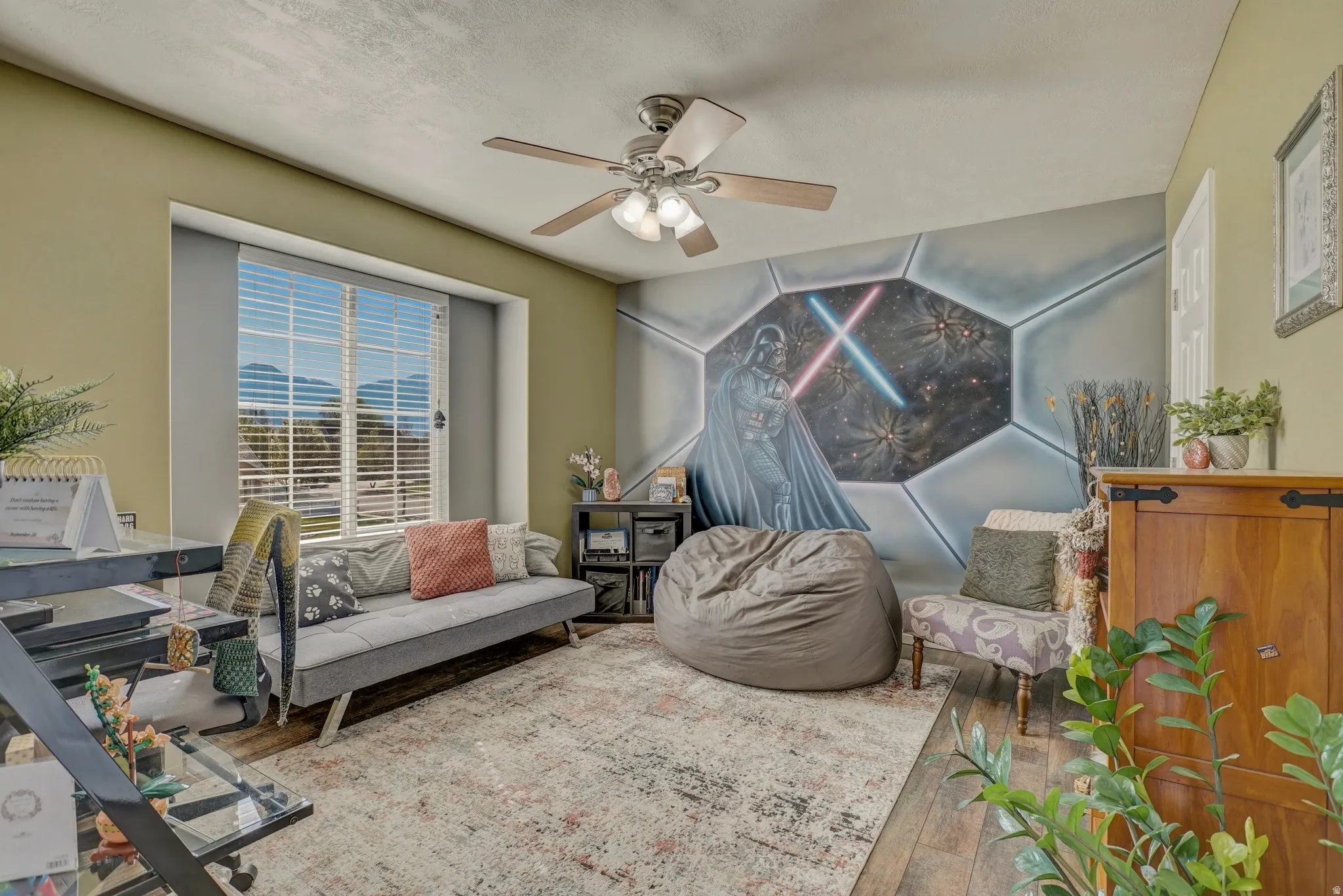 Living area featuring wood finished floors and ceiling fan
