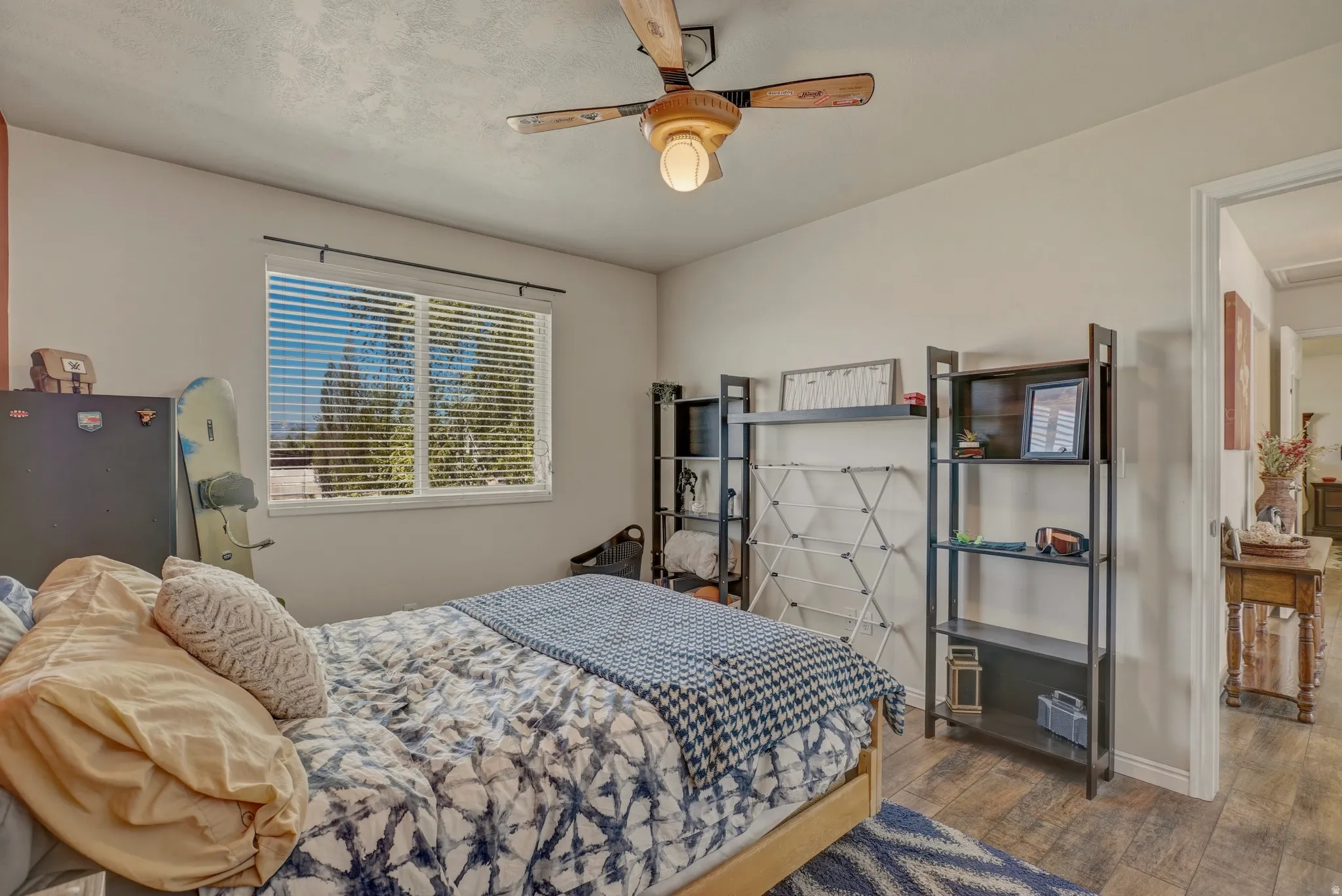 Bedroom with dark wood-type flooring and a ceiling fan