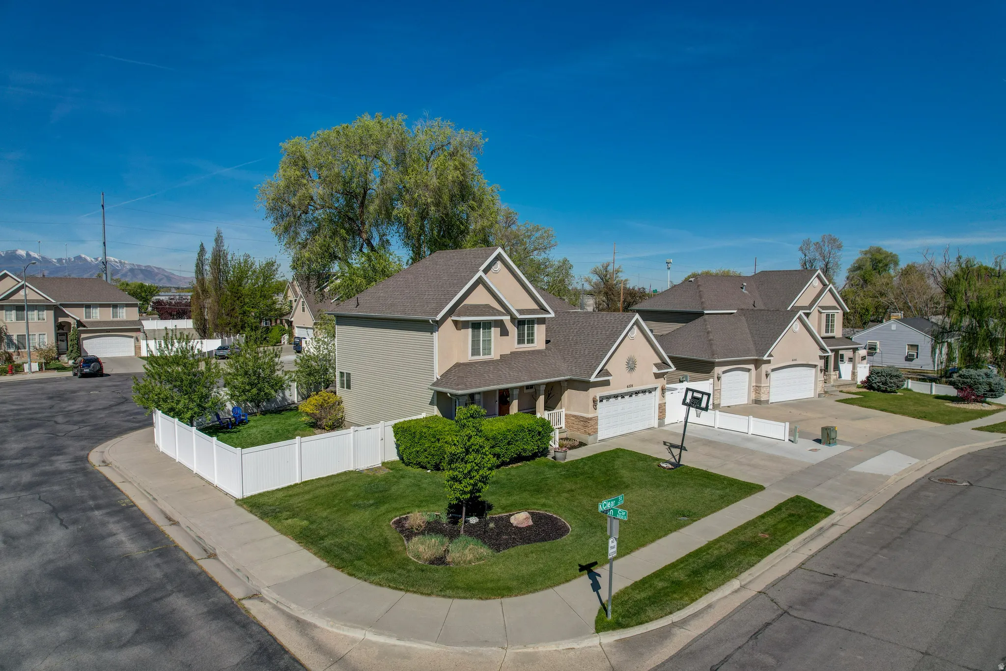 View of front of property featuring a residential view, driveway, and stone siding