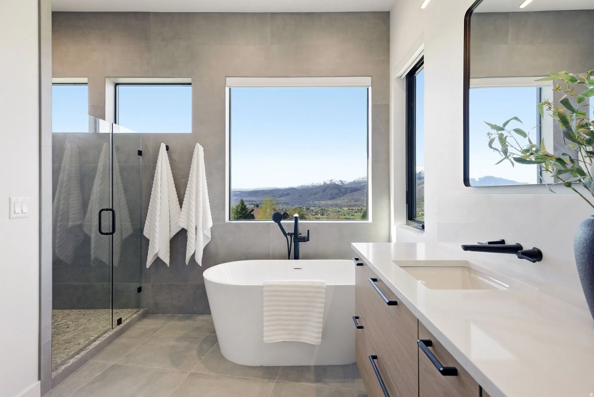 Bathroom featuring vanity, a shower stall, and a freestanding bath