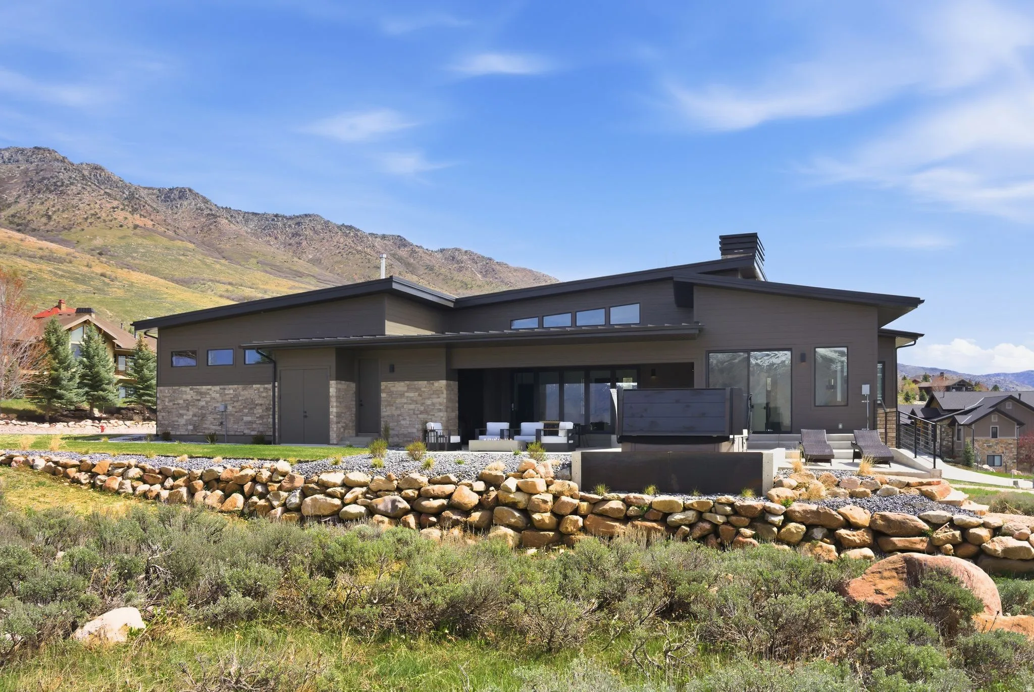Back of property featuring a mountain view, a patio area, and a chimney