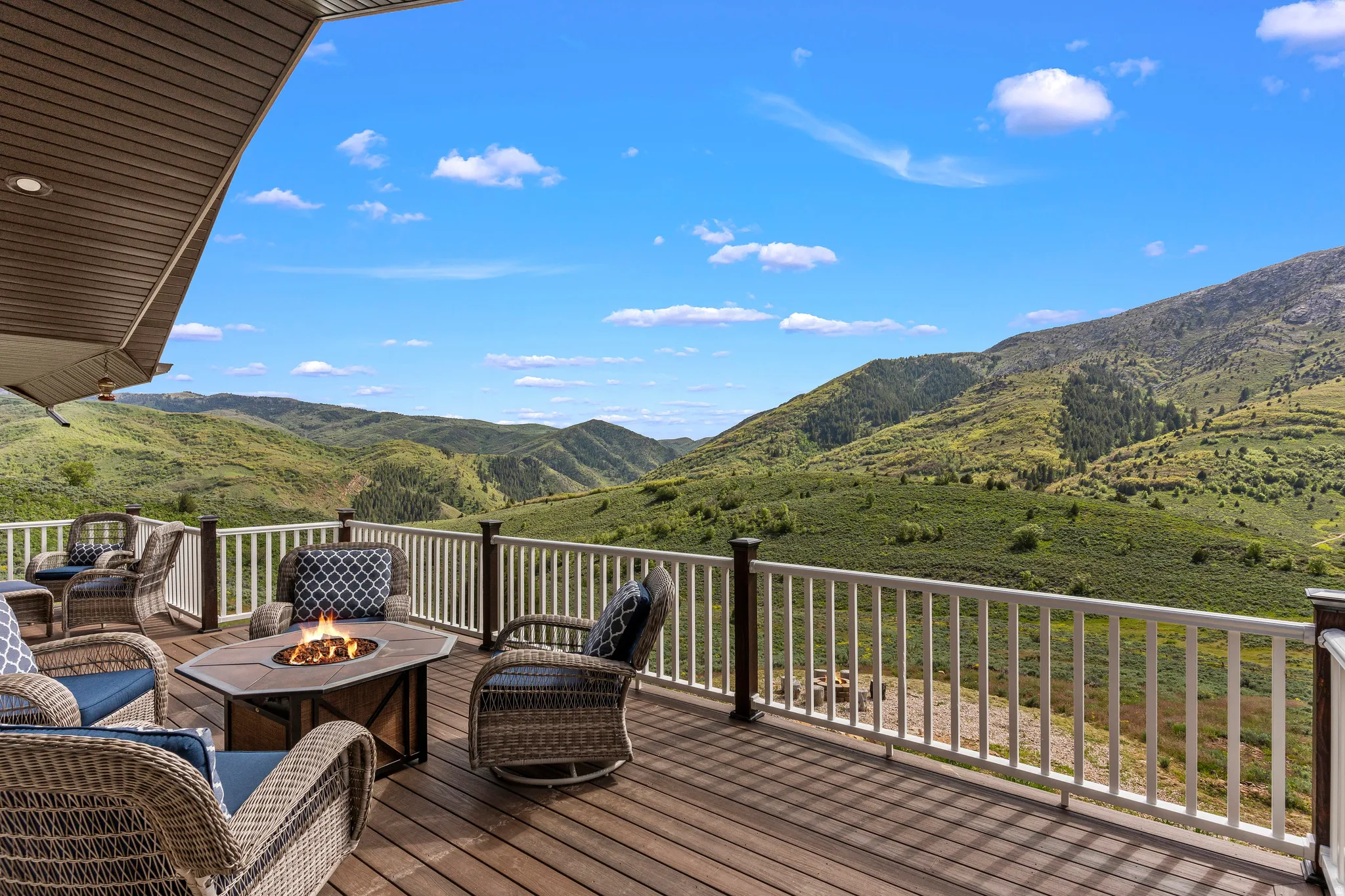 Wooden terrace featuring a fire pit and a mountain view