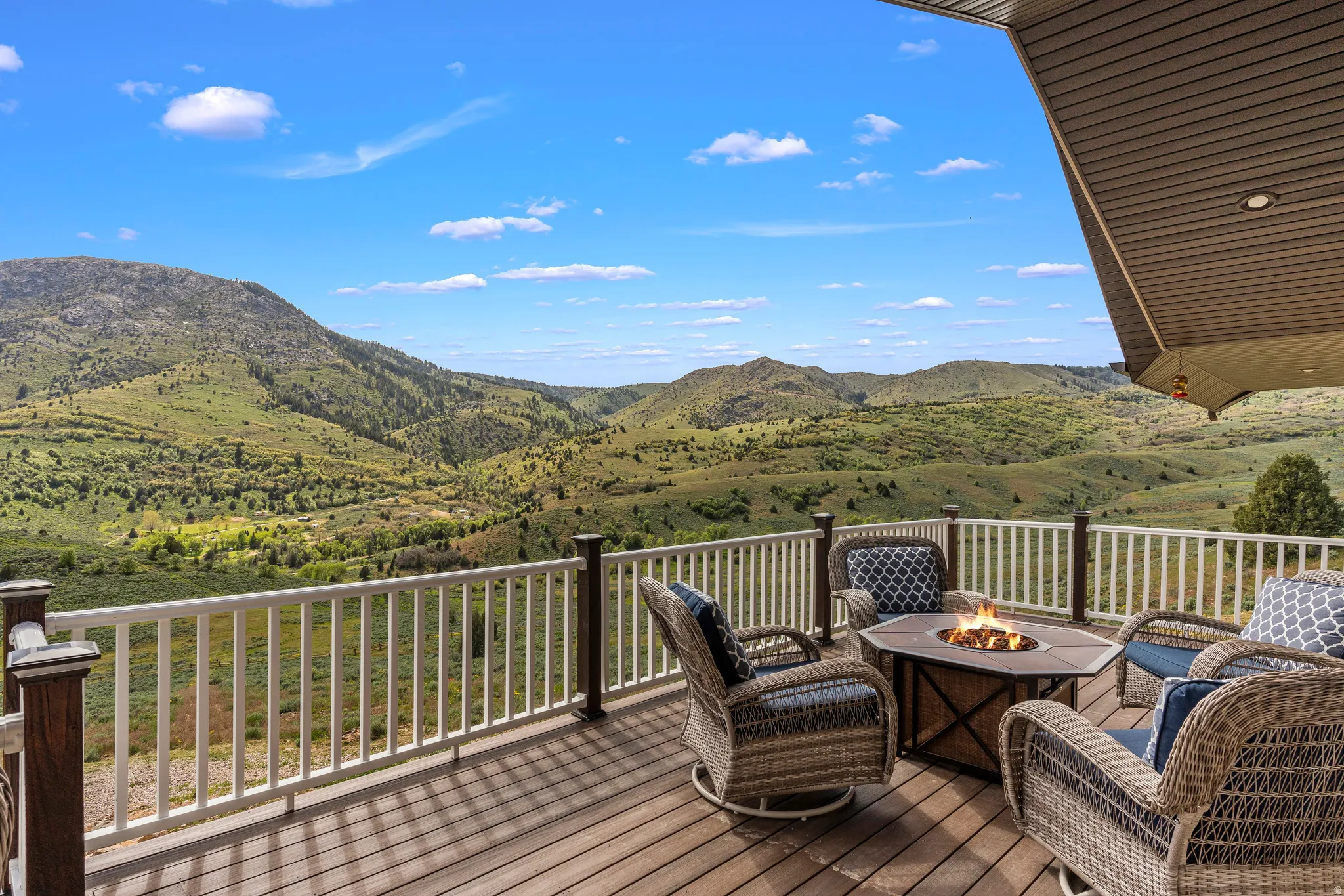 Deck with a fire pit and a mountain view