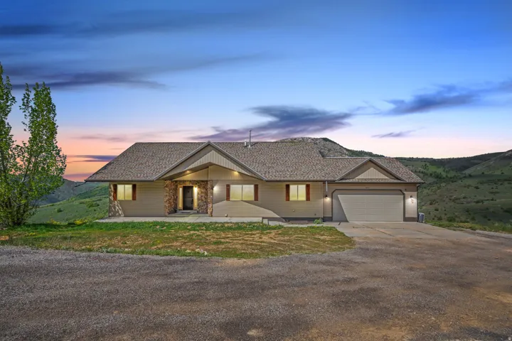 Ranch-style home featuring concrete driveway and an attached garage