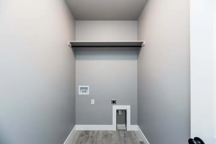 Laundry room featuring hookup for an electric dryer, washer hookup, and light wood-style floors