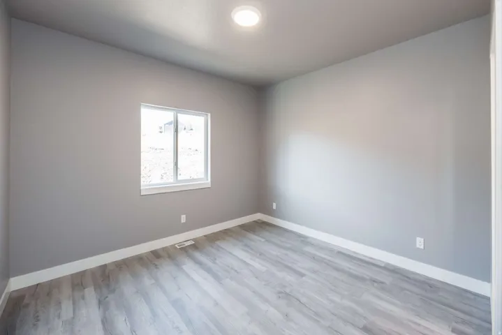 Unfurnished room featuring baseboards and light wood-type flooring