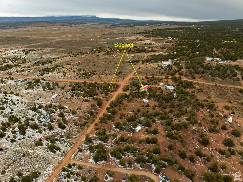Overview of rural landscape featuring a desert landscape and a mountainous background
