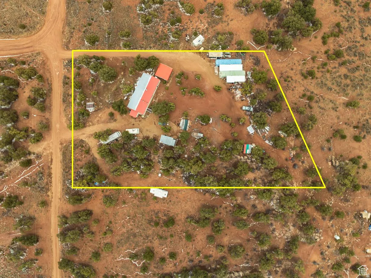 Aerial view of sparsely populated area featuring property boundaries highlighted and a desert landscape