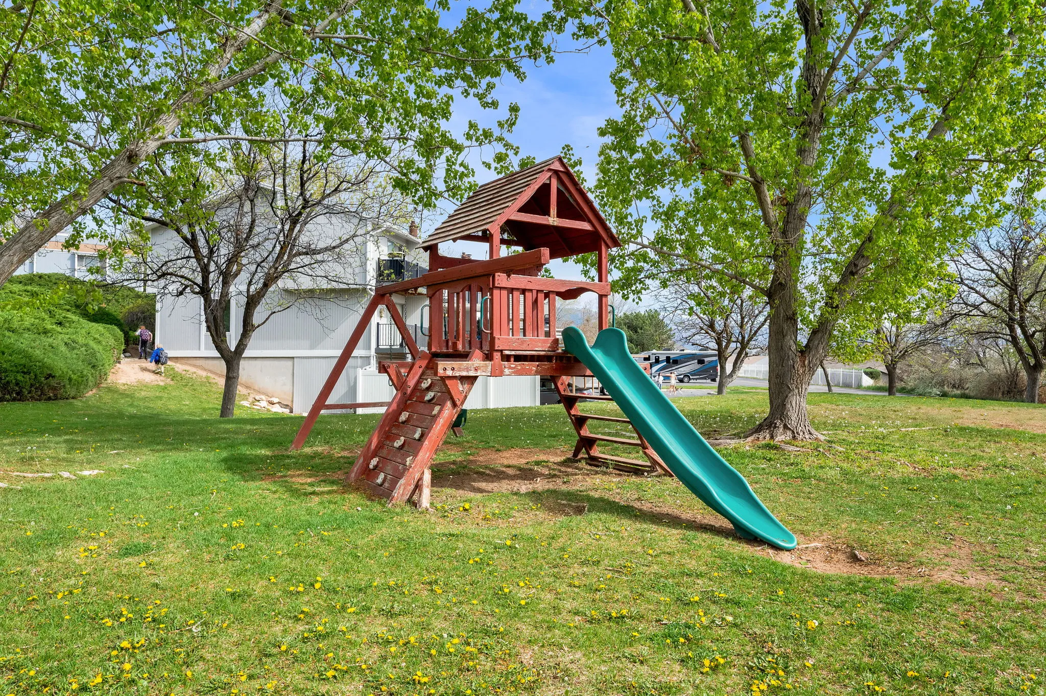 View of playground with a lawn