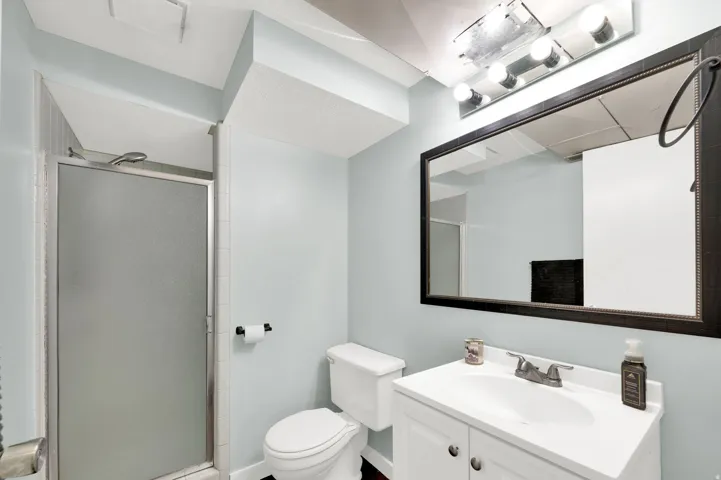 Bathroom featuring vanity and a stall shower