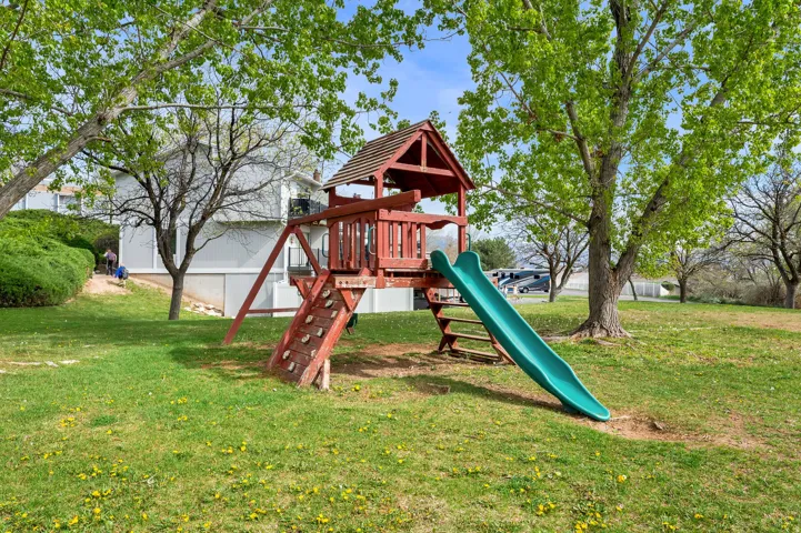 View of playground with a lawn
