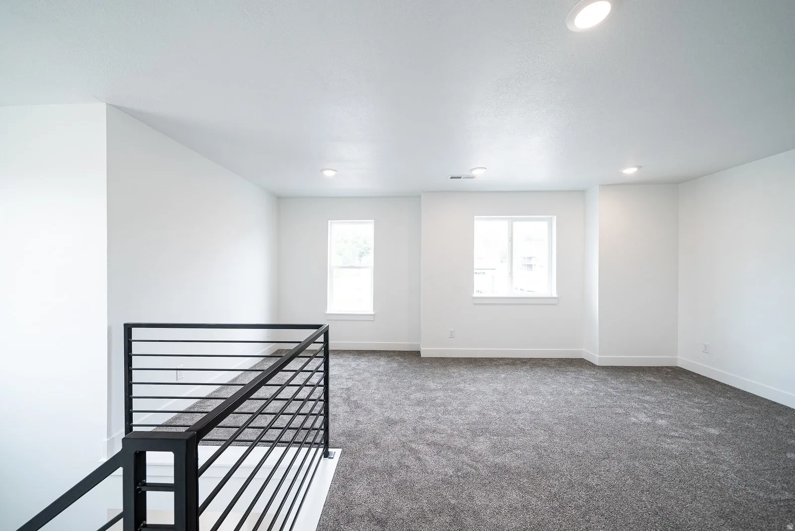 Carpeted spare room with recessed lighting
