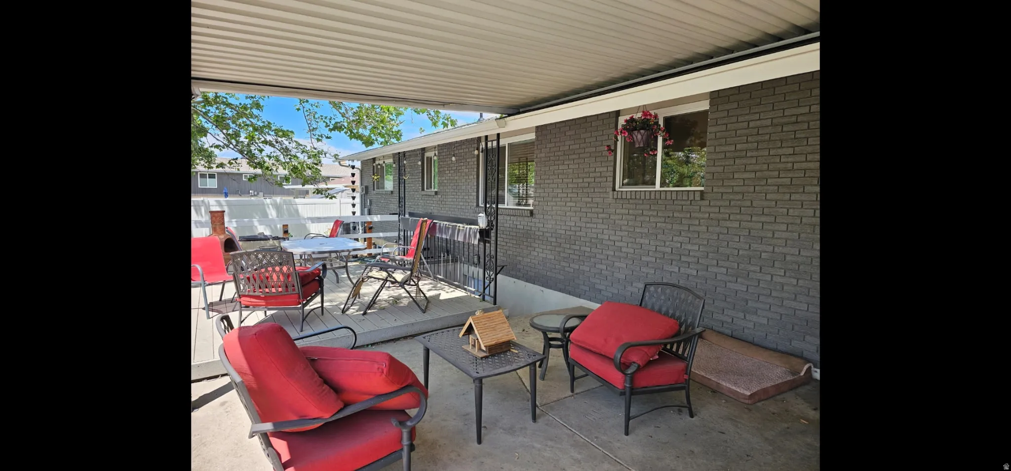 View of patio with outdoor dining space and a wooden deck