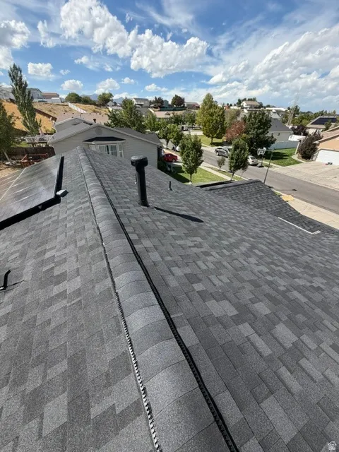 Multi-toned asphalt shingle roofing with a prominent ridge vent