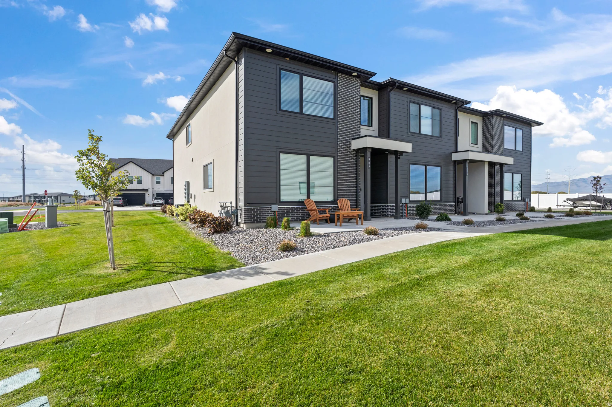 Modern home with a front yard and a mountain view