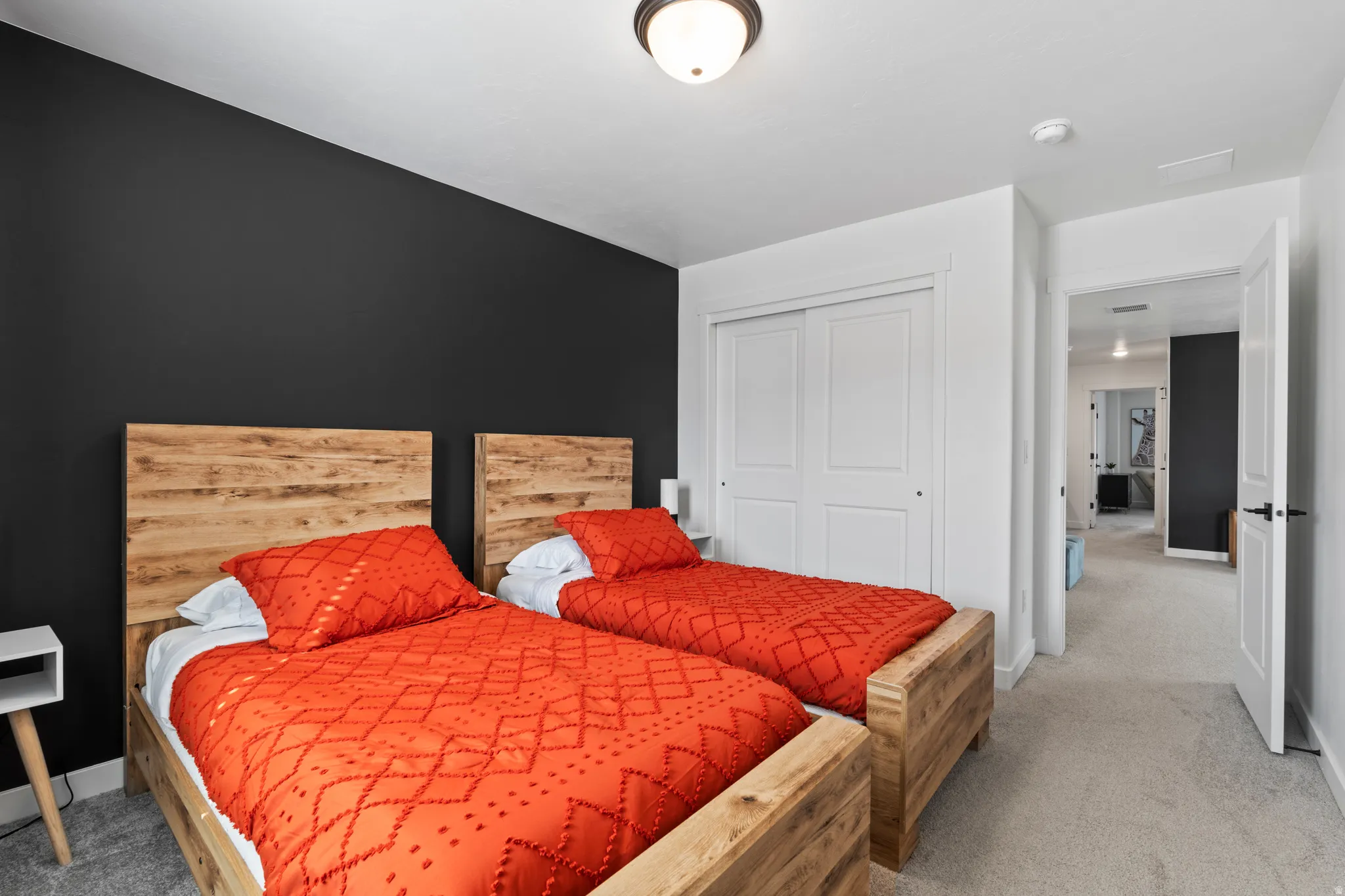 Bedroom with light carpet and a closet