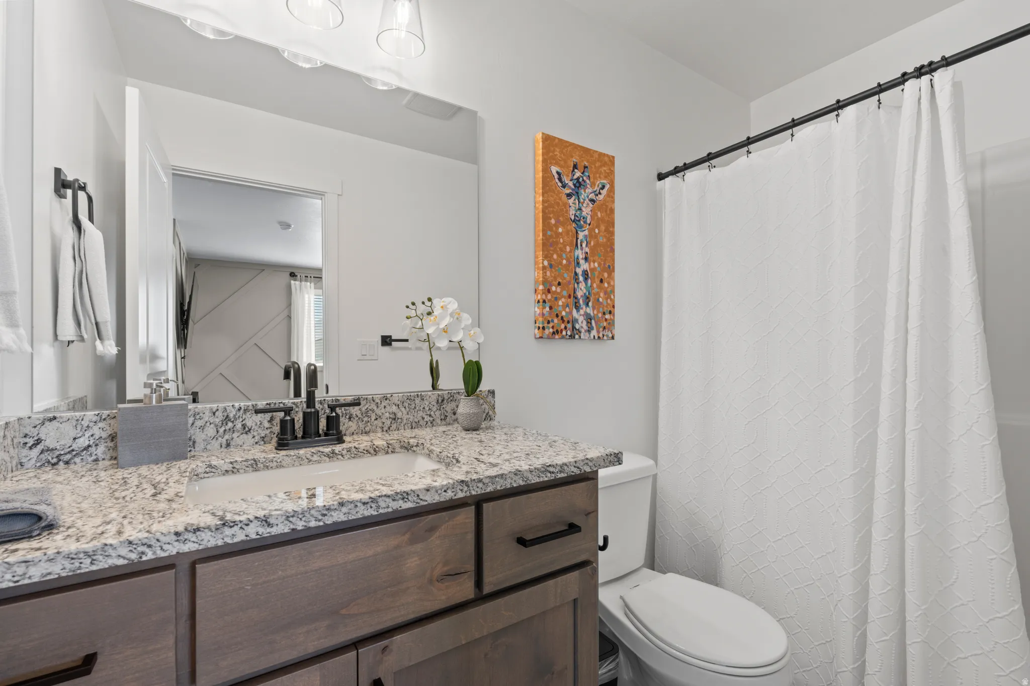 Bathroom featuring vanity and a shower with curtain