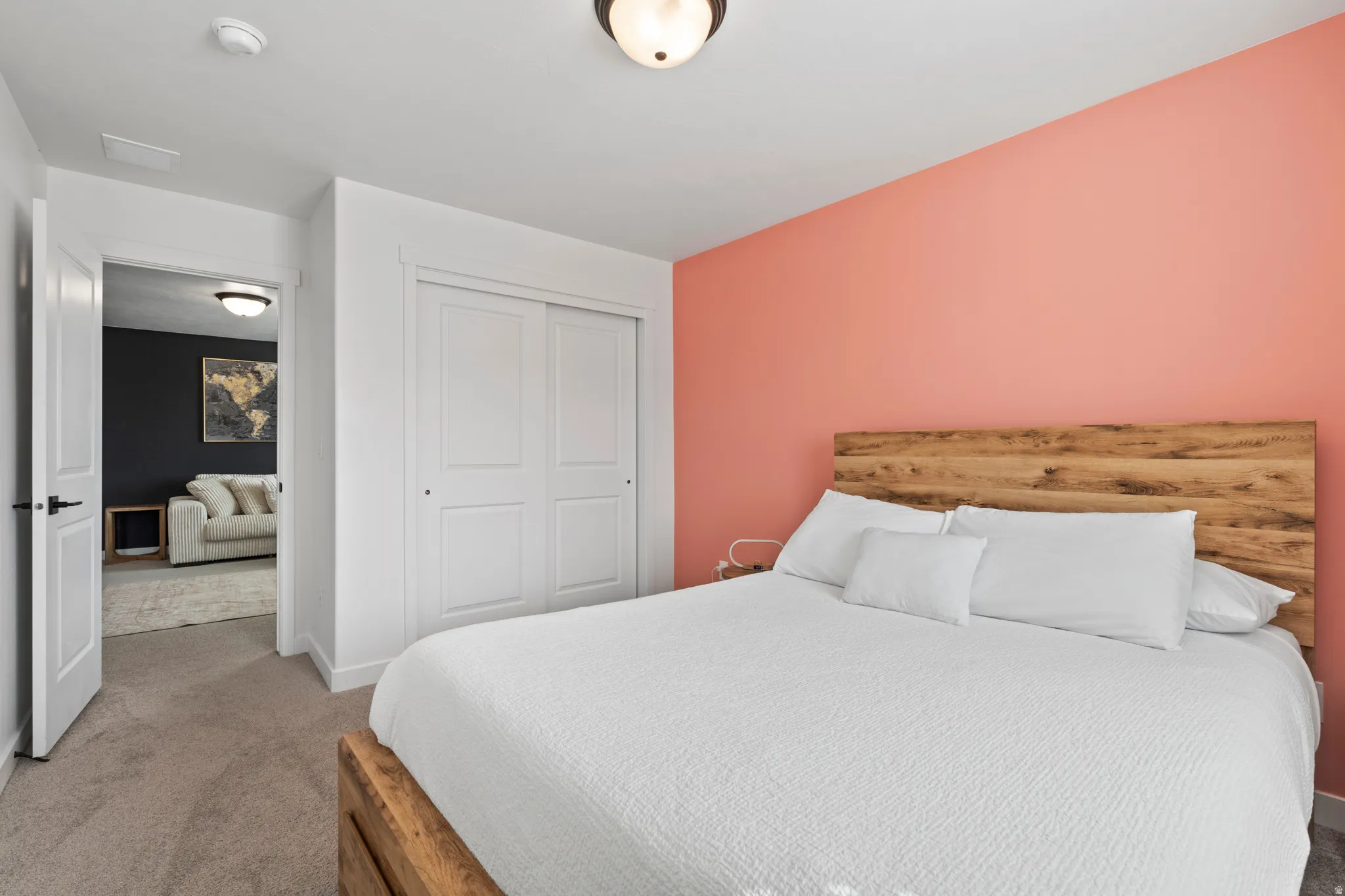Bedroom with light carpet and a closet