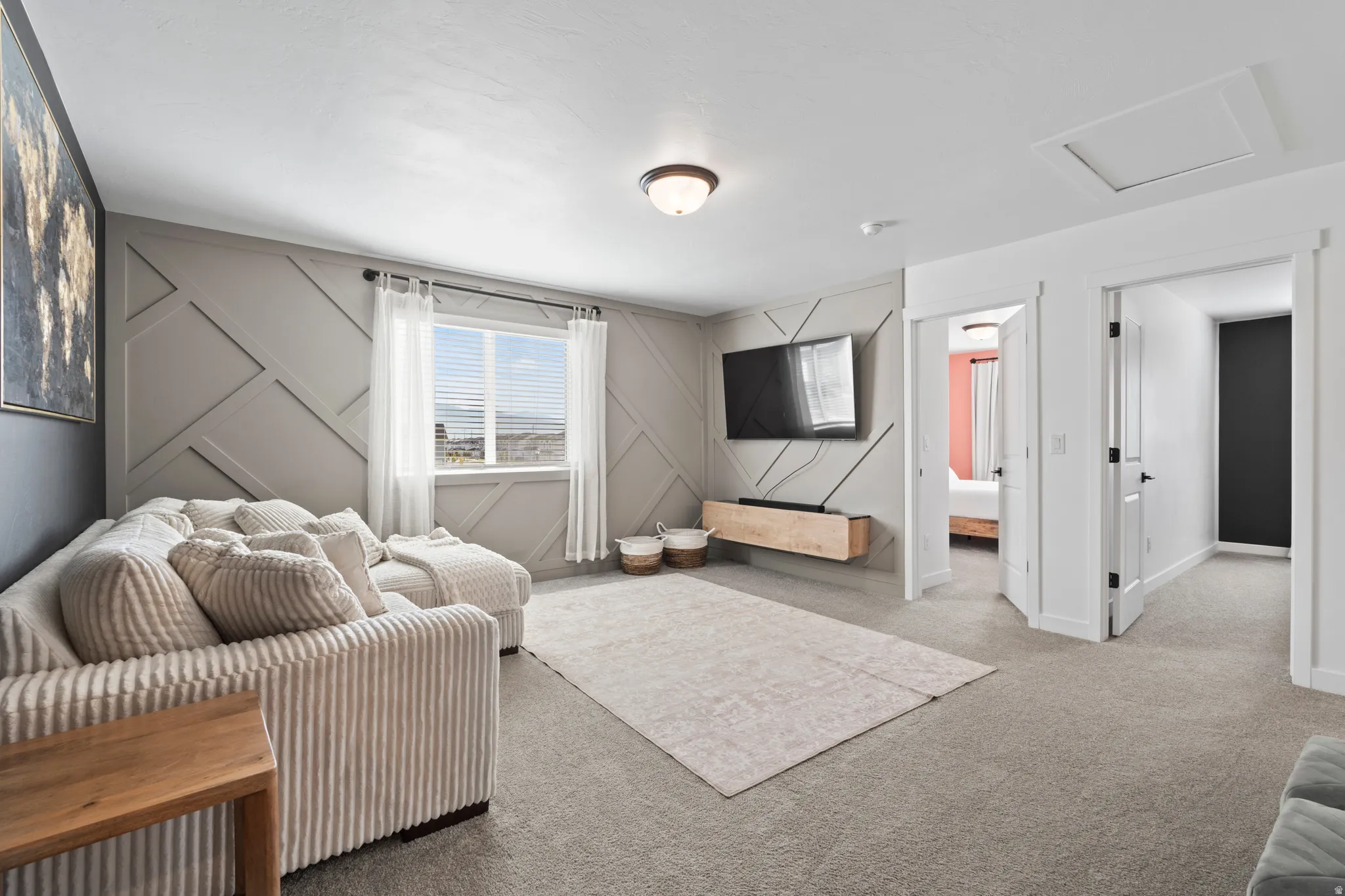 Bedroom with a decorative wall and carpet