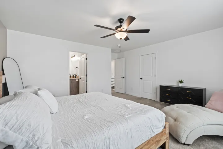 Bedroom with carpet and a ceiling fan