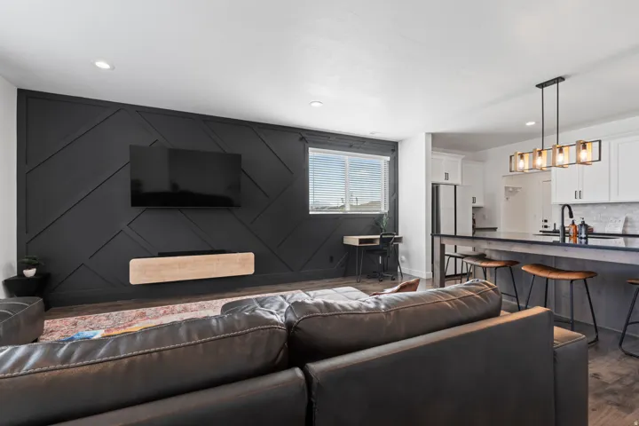 Living area with dark wood-type flooring and recessed lighting