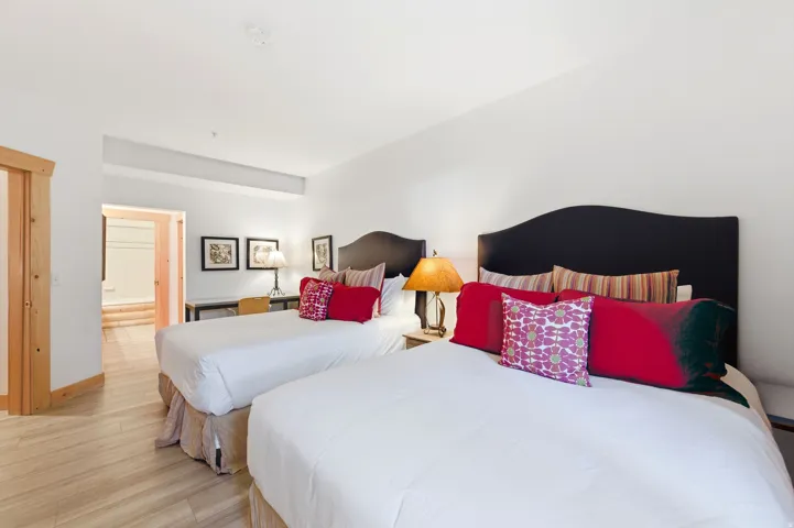 Bedroom with light wood-type flooring and ensuite bath