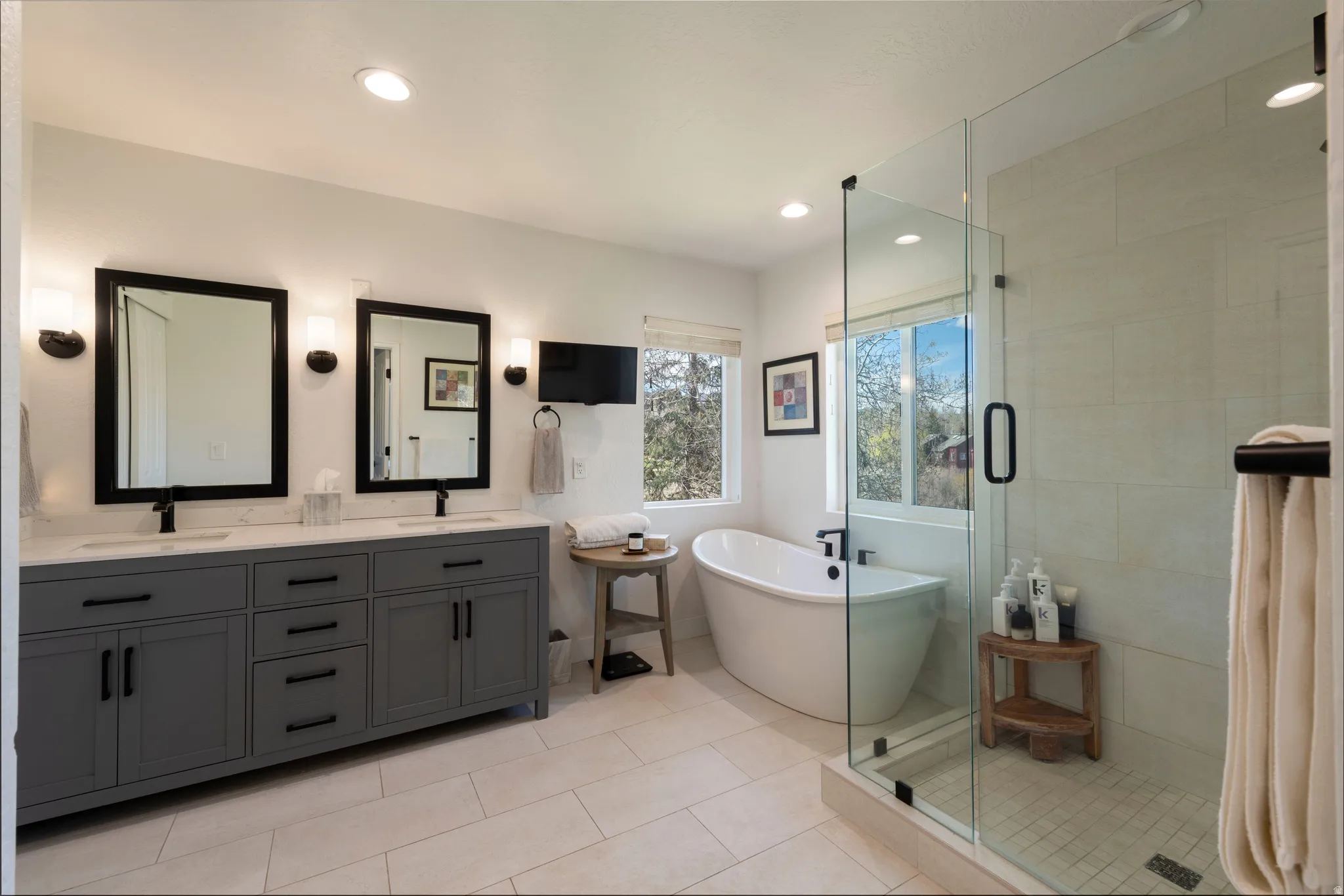 Bathroom with double vanity, a soaking tub, a shower stall, light tile patterned floors, and recessed lighting