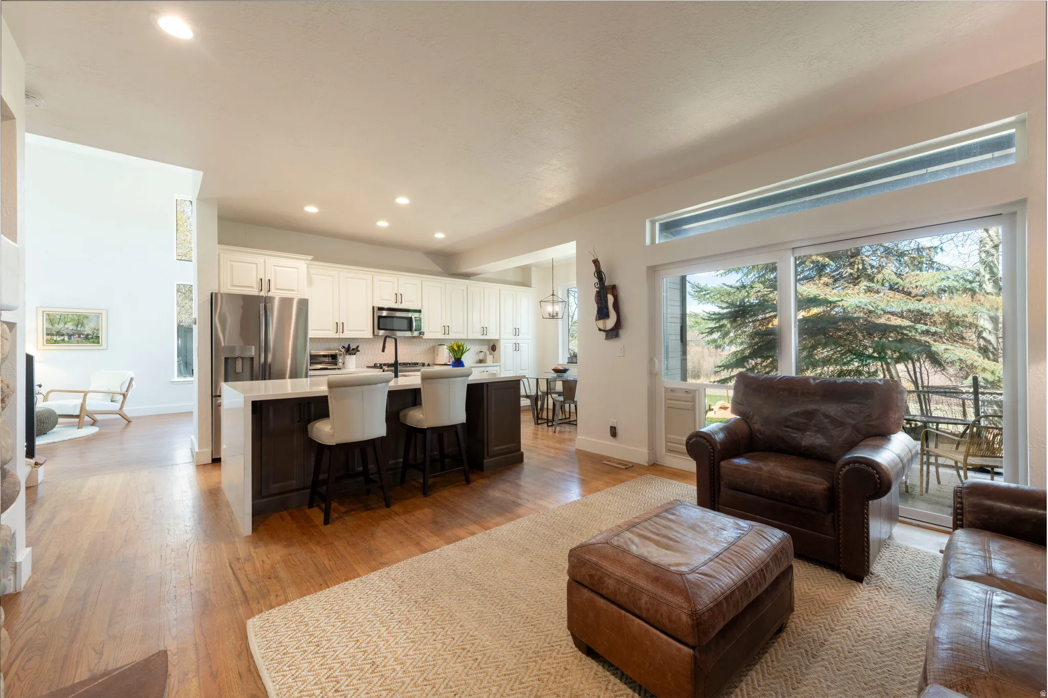 Living room with light wood-style floors and recessed lighting
