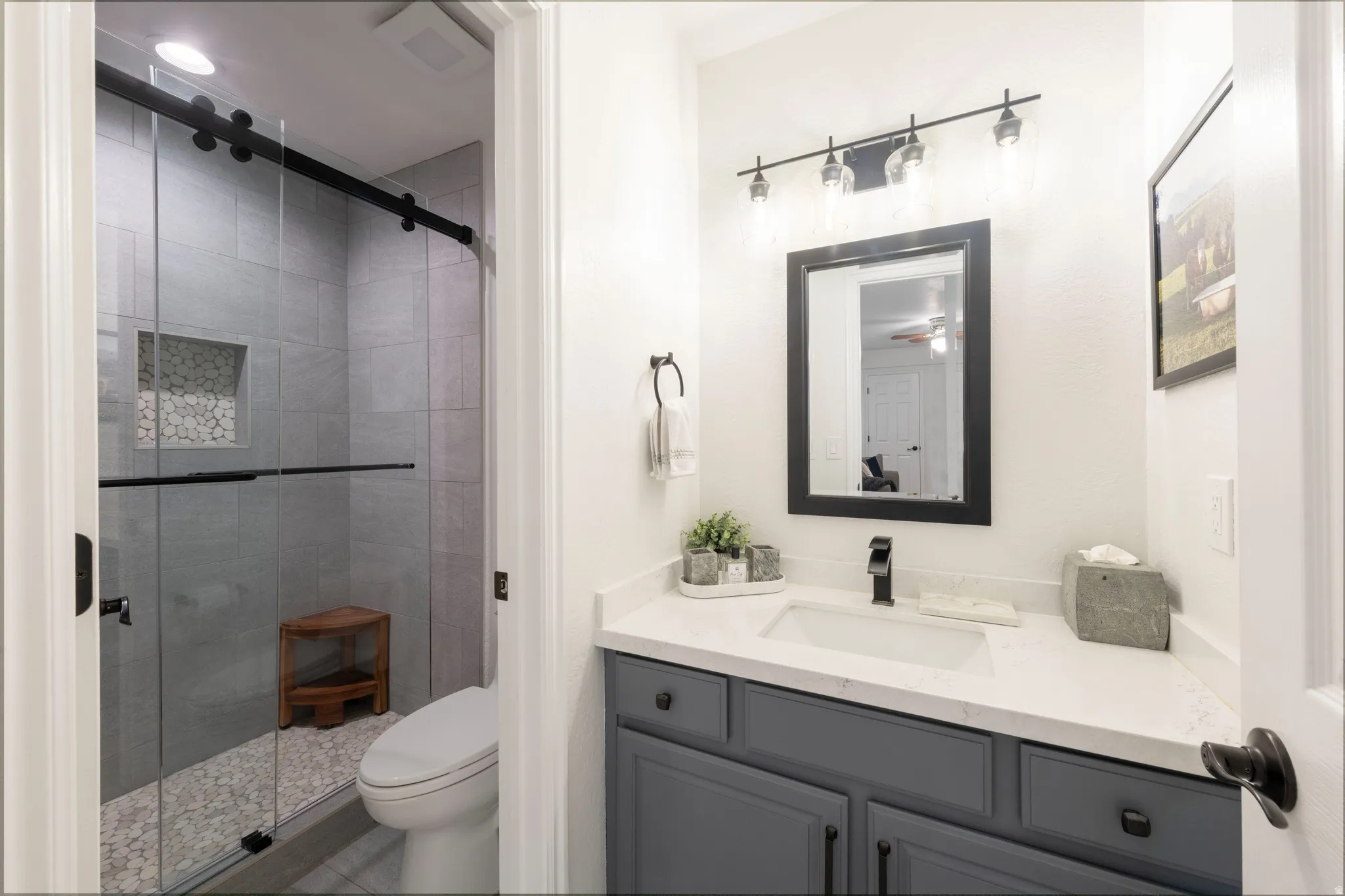 Bathroom featuring vanity and a shower stall