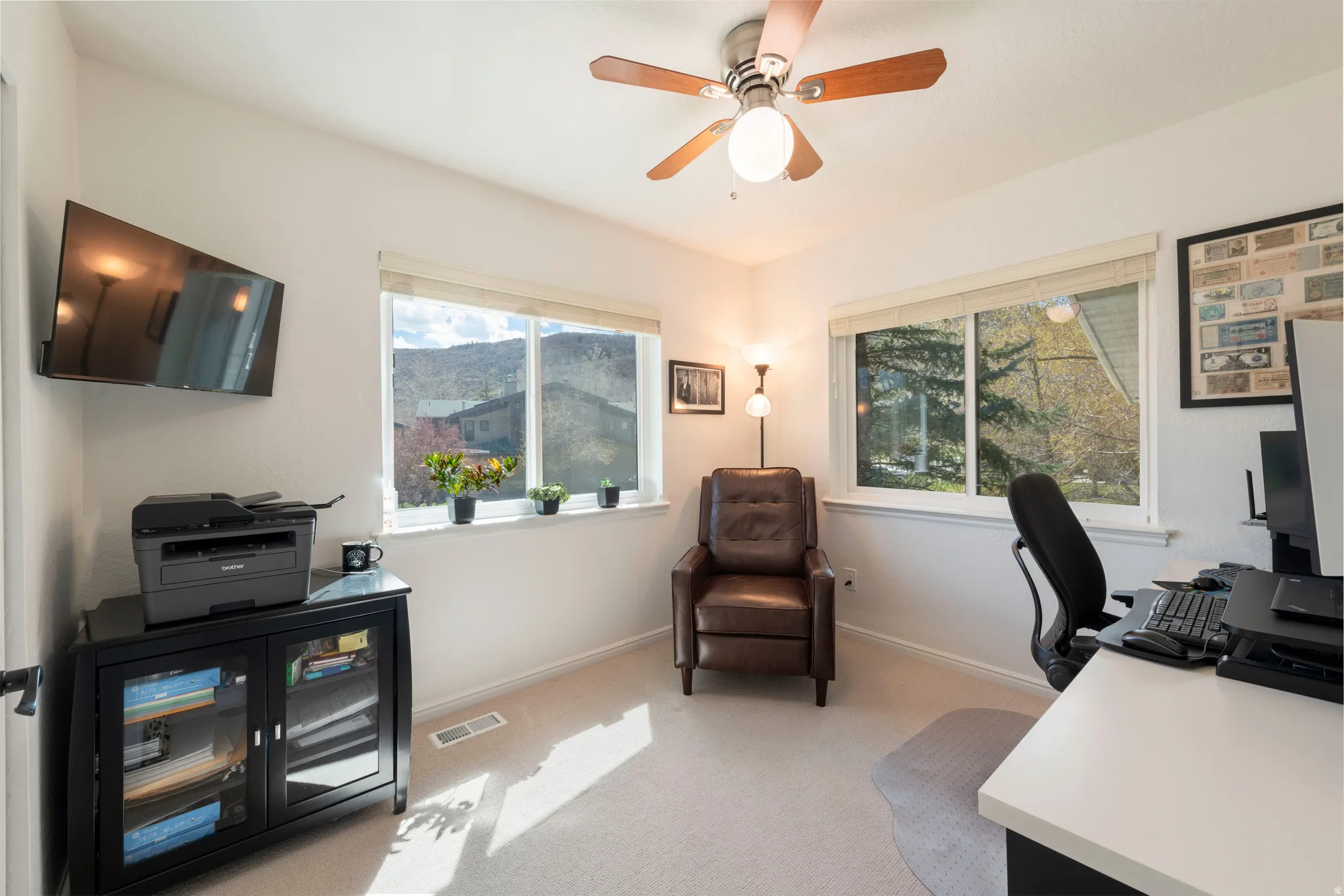Office space featuring light carpet and ceiling fan