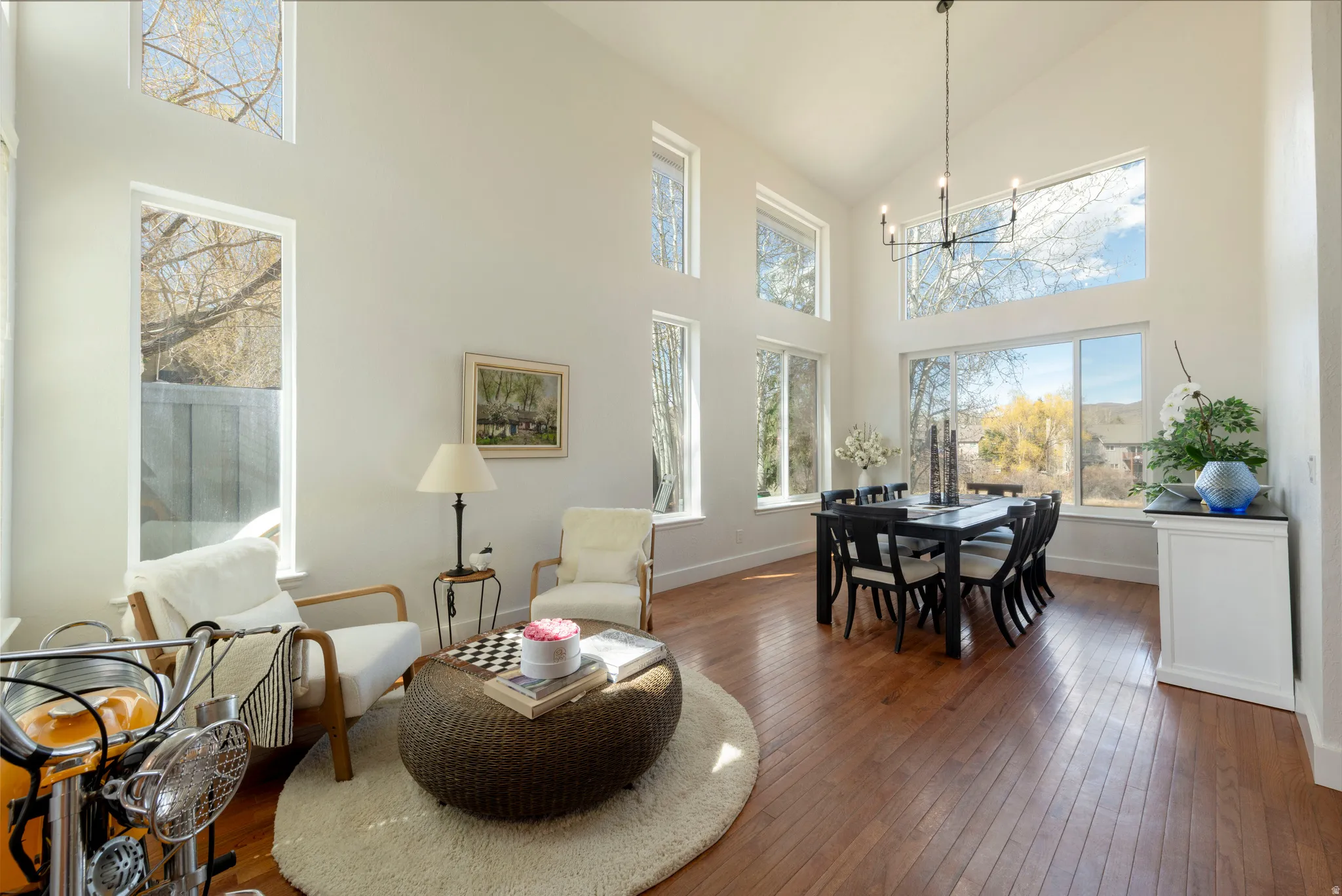 Dining space featuring dark wood-style flooring, lofted ceiling, and a chandelier