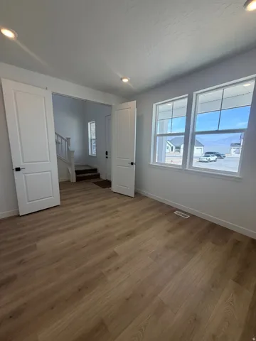 Unfurnished bedroom featuring wood finished floors and recessed lighting