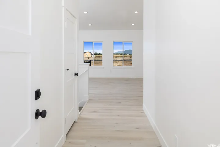 Hall with recessed lighting and light wood-style floors