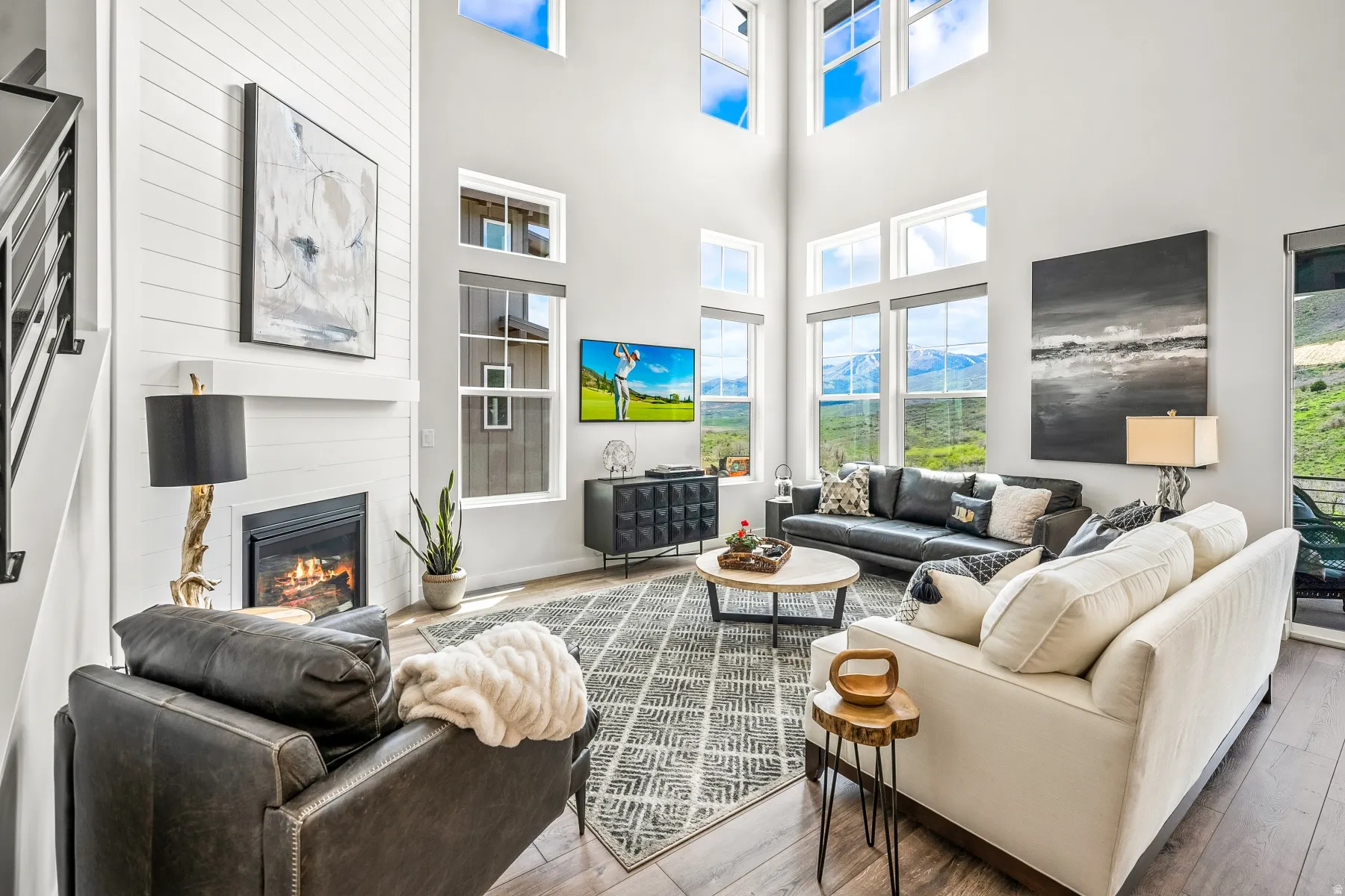 Living area featuring a large fireplace and wood-type flooring