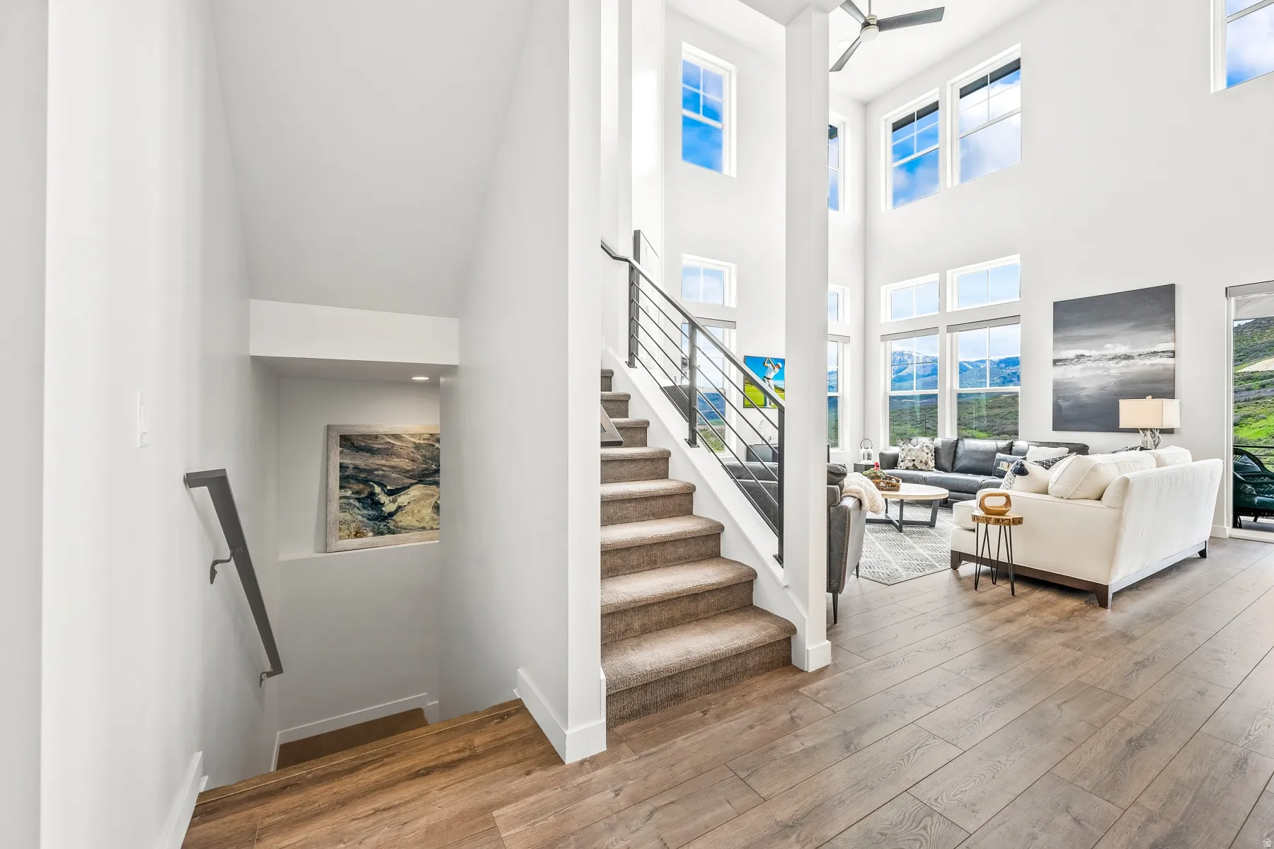 Staircase with hardwood / wood-style flooring and a high ceiling