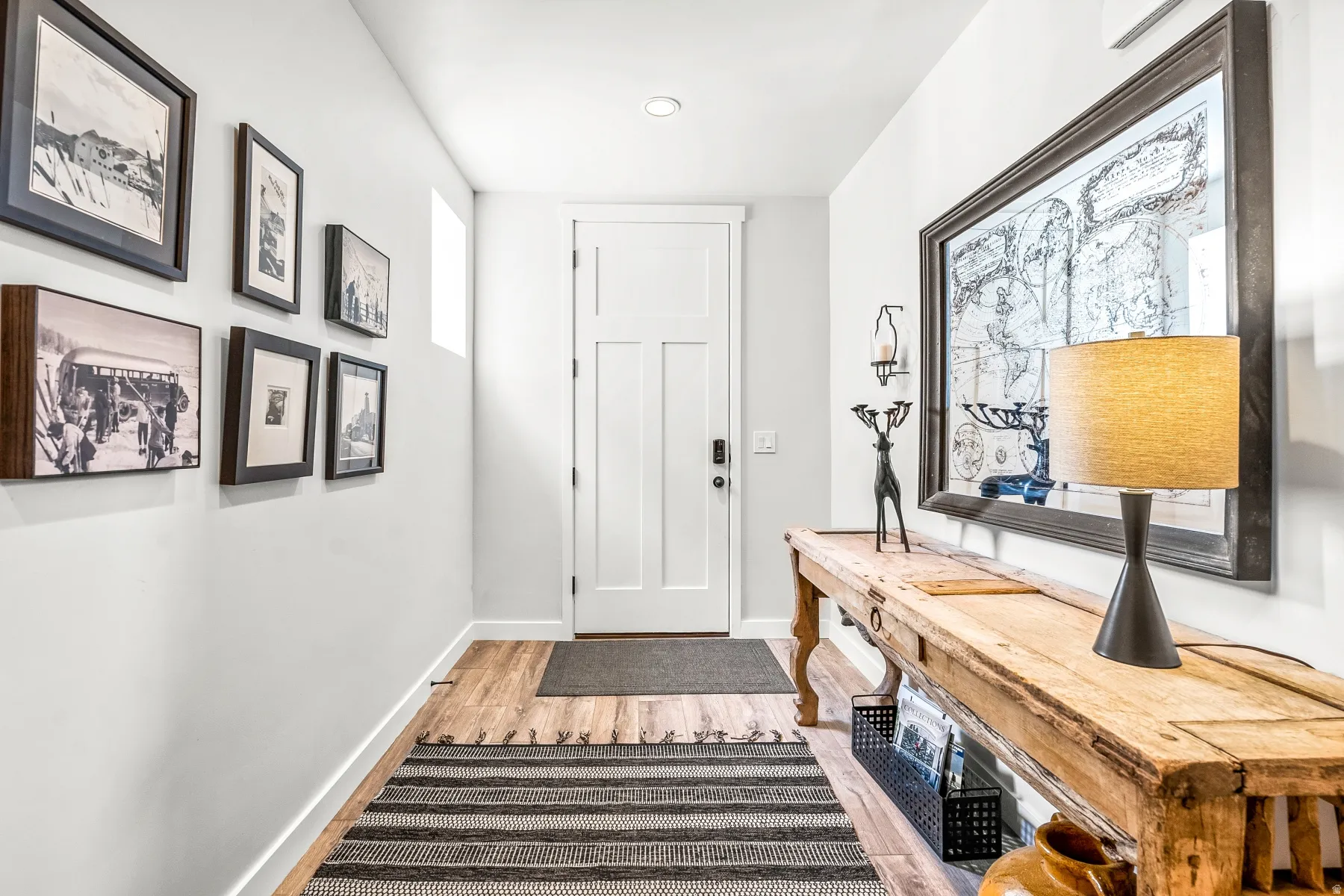 Doorway with wood finished floors and baseboards